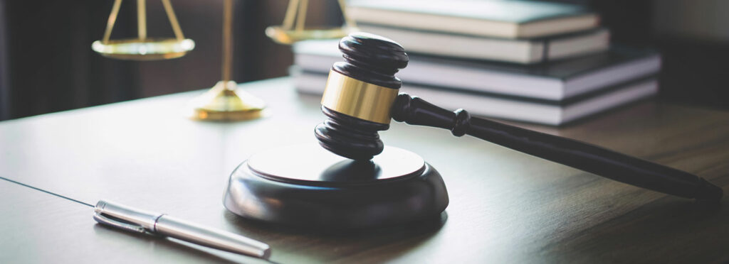 Johnson & Johnson Ordered to Pay $572 Million for Role in Opioid Crisis 3 gavel on desk with justice scales